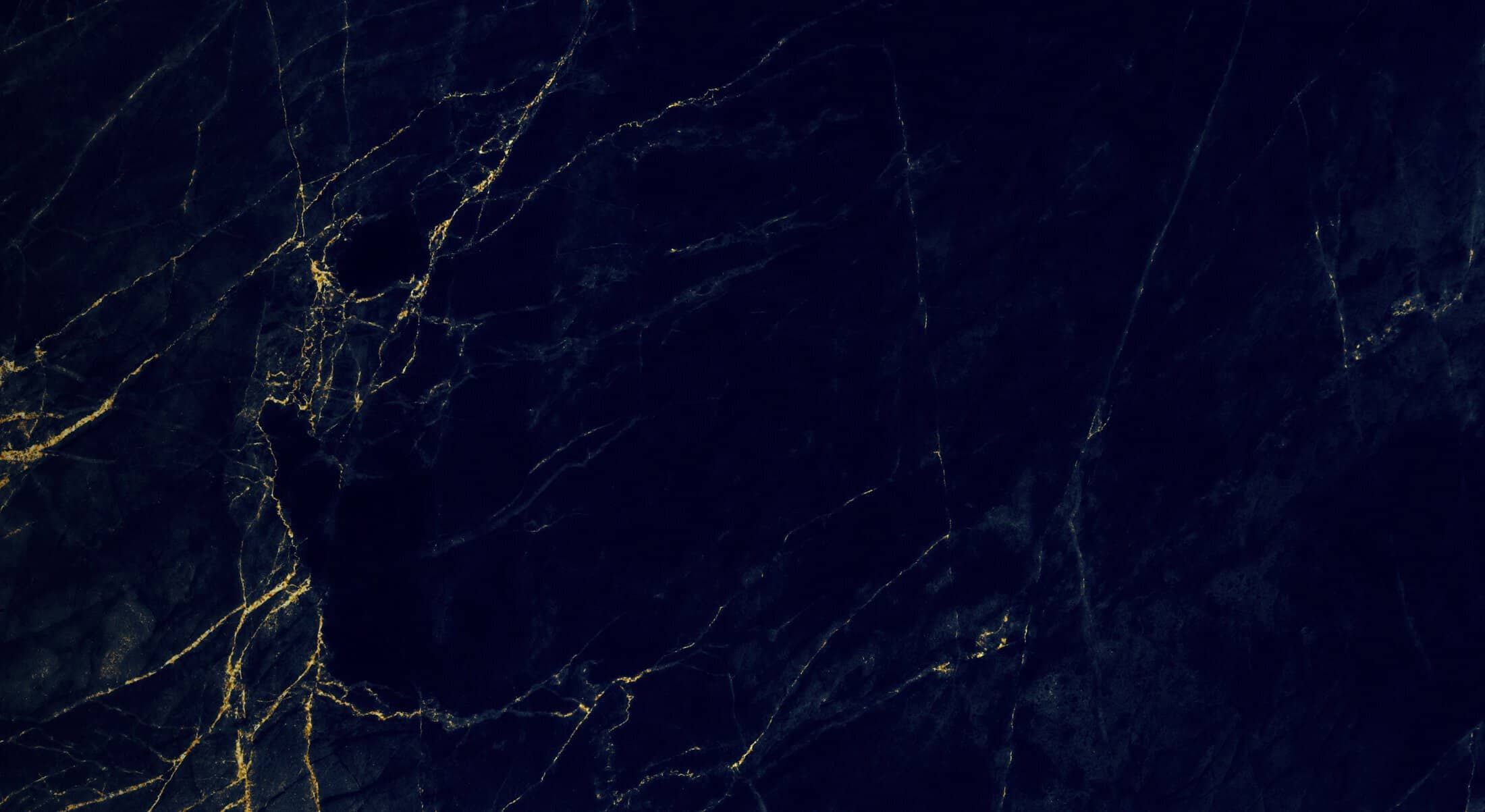 Dark marble texture with golden veins.
