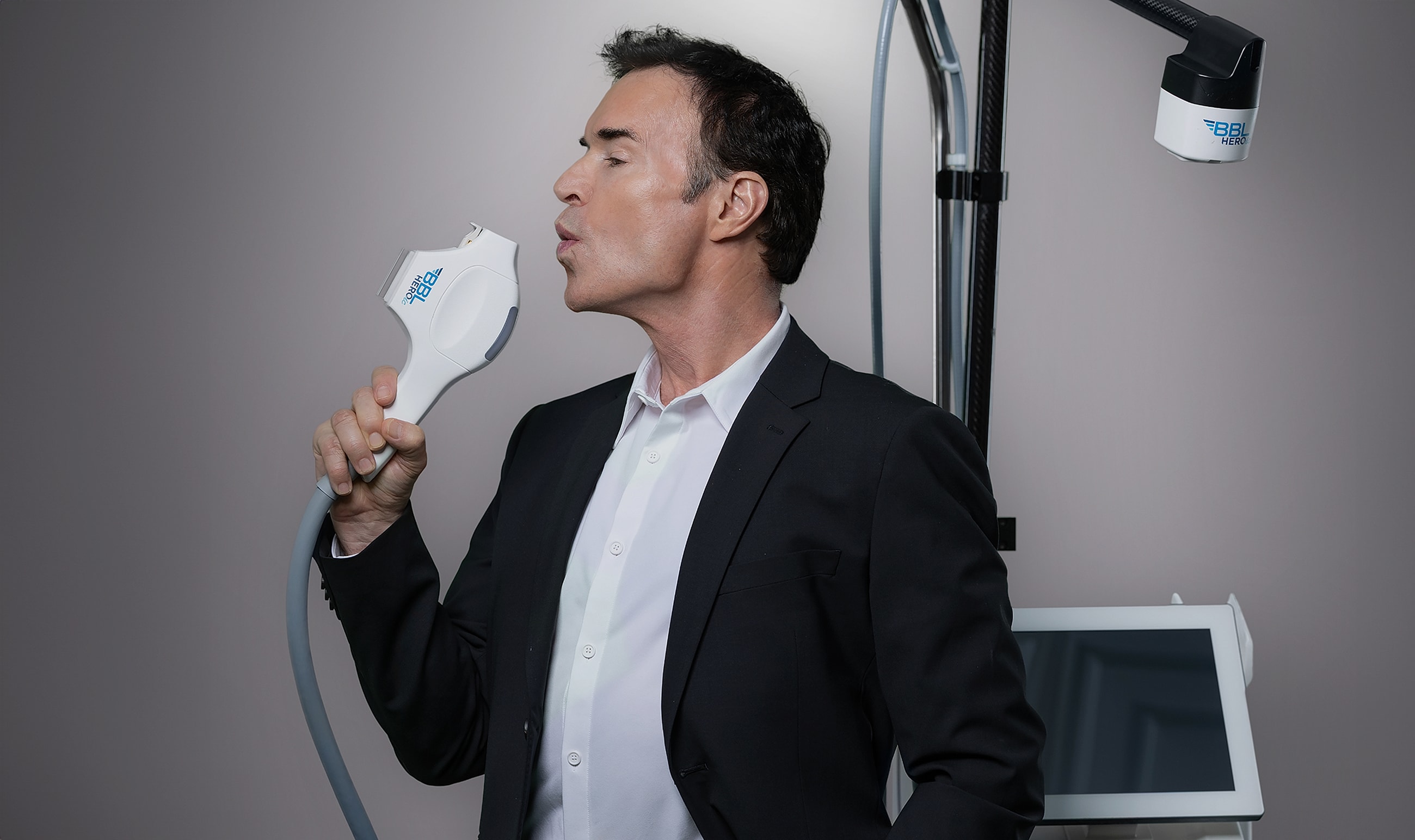 Man posing with a skincare treatment device.